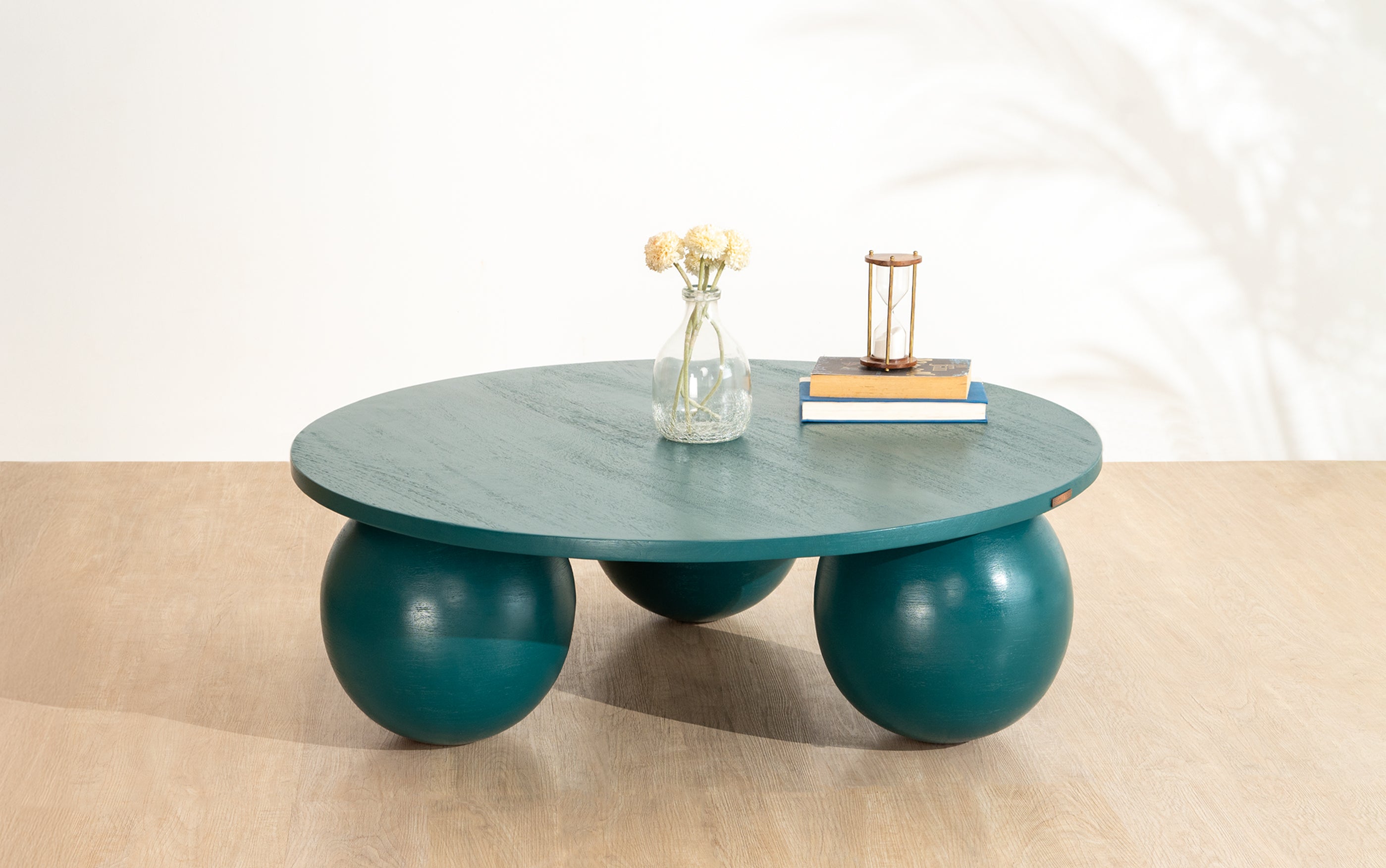 Ala Coffee Table in green stained mango wood, a modern round center table design ideal for living room decor and stylish coffee table designs.