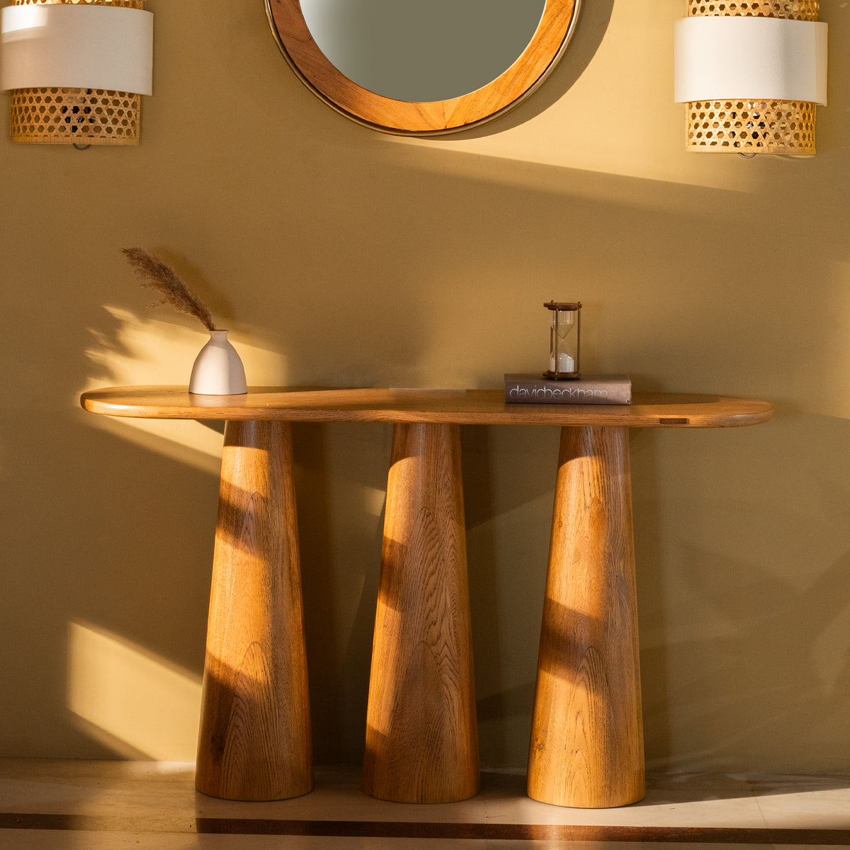 Hump console table made from oak wood with light brown cerused finish, featuring three sculpted legs. Ideal for living rooms or as a TV console.