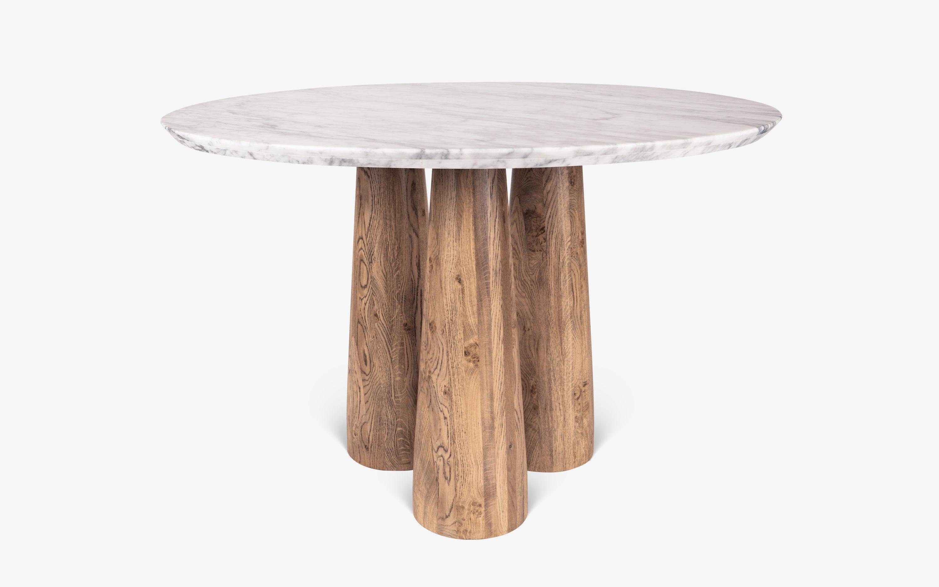 Hump Round Dining Table with Carrara Marble Top and Oak Wood Legs in light brown cerused finish. Luxury marble top dining table for elegant dining rooms.