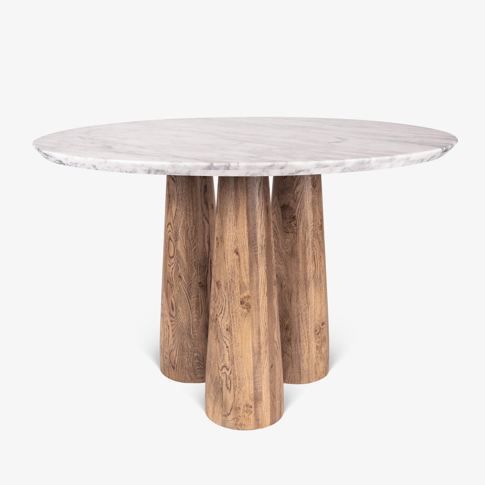 Hump Round Dining Table with Carrara Marble Top and Oak Wood Legs in light brown cerused finish. Luxury marble top dining table for elegant dining rooms.