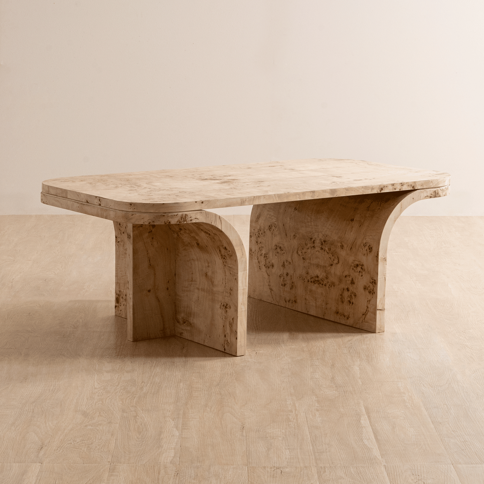 Nouve Coffee Table with Burl Veneer finish, featuring architectural curves and luxe surfaces. A modern and opulent wooden coffee table for living rooms